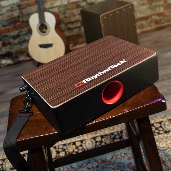 Rhythm Tech Bongo Cajon on wood stool with acoustic guitar and cajon in background