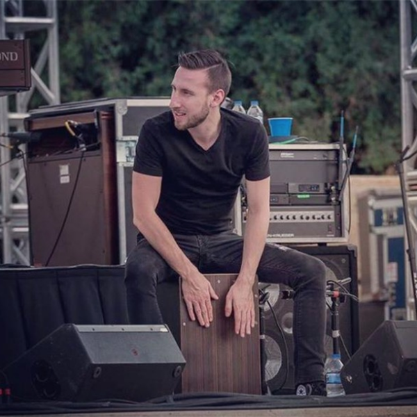 man playing cajon at outdoor concert