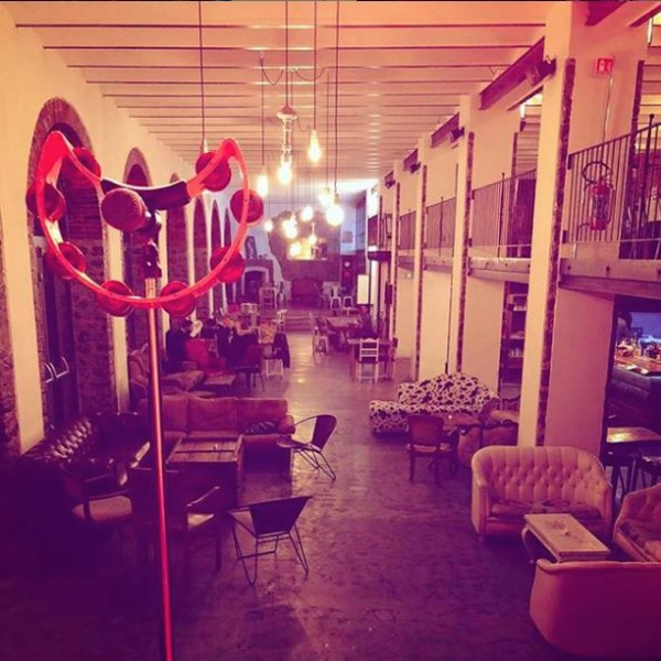 red crescent-shaped tambourine hanging on microphone stand at sophisticated indoor venue