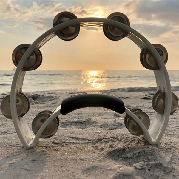 white crescent-shaped tambourine at beach during sunset