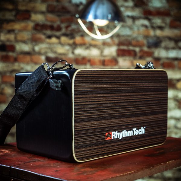 Rhythm Tech Bongo Cajon on wood table in front of brick wall