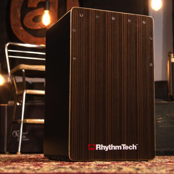 Rhythm Tech cajon in front of hanging light bulbs and metal chair