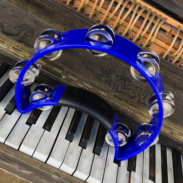 blue Rhythm Tech crescent-shaped tambourine on vintage piano