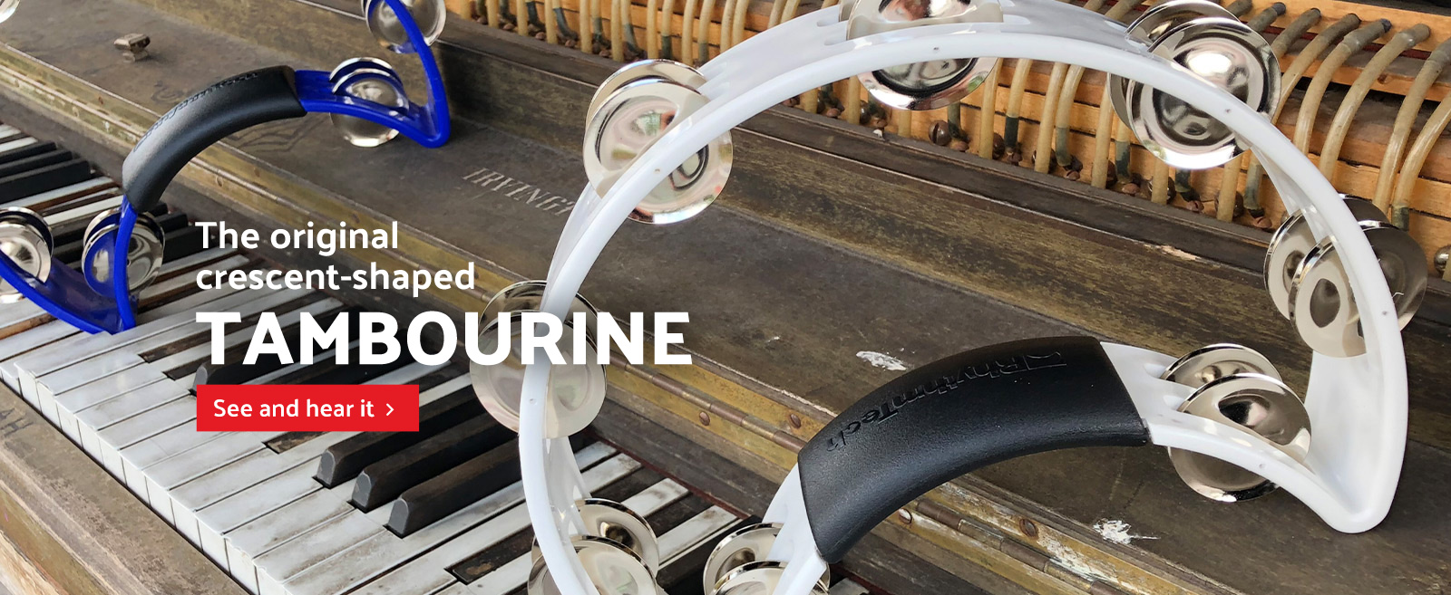 two crescent-shaped tambourines on top of vintage piano